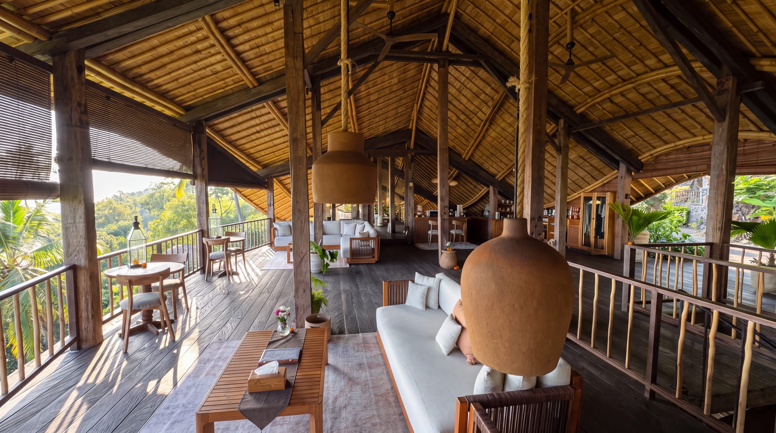 Interior lounge with white sofas, reclaimed wood beams, and a bamboo ceiling